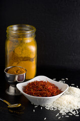 Macro Image of Fresh Saffron, Turmeric and White Rice with Dark Background