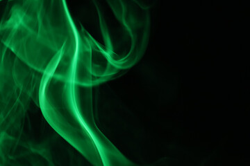 Obraz premium Green lines, green smoke on a dark background, colourful abstract, green fog, minimalism, line of light 