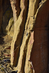 Climbers on sheer face of basalt spire in Red Rock state park, central Oregon near towns of Bend and Redmond