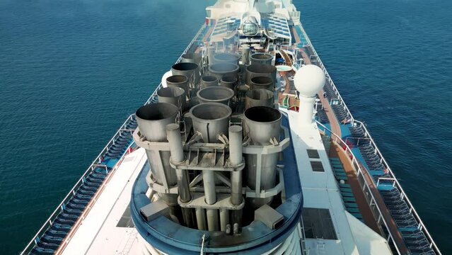 Black smoke from the chimneys of a cruise ship. Aerial view of a cruise ship in open water. Air Exhausting HD Slow motion. Vietnam. 4K