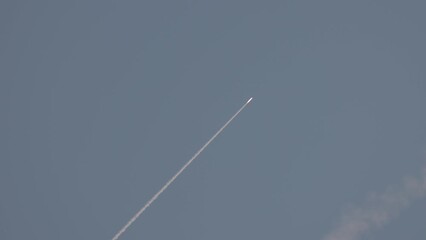 Missile attack. An anti-aircraft missile has the rocket is flying to the target in the blue sky. Air defence. War in the sky. SAM. Slow motion 120 fps, ProRes 422, 10 bit, ungraded C-LOG video