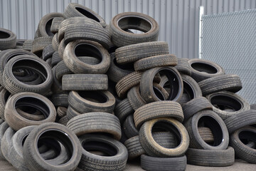 Pile of old car tires. Used car rubber tire. Rubber recycling.