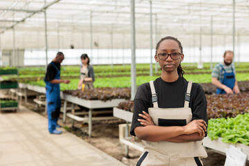 African american ranch manager leading horticulture team of farmers growing locally chemical free...