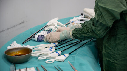 Laparoscopic surgery preparations and supplies. Nurse is preparing equipment for laparoscopic...
