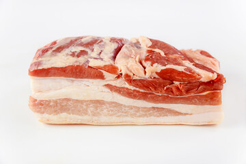 Raw pork belly with spices on a white background.