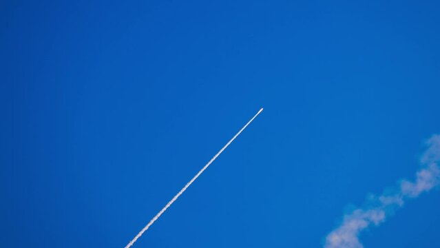 Missile attack. An anti-aircraft missile has the rocket is flying to the target in the blue sky. Air defence. War in the sky. Smoke in the sky after air missile SAM. slow motion video
