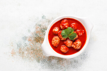 Chicken meatballs with tomato sauce.