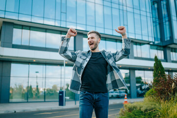 In the heart of the city, a bearded Caucasian man revels in the sweet taste of victory. His laughter echoes through the streets as he savors his achievement, portraying genuine happiness.