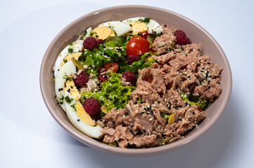 tuna salad with lettuce and eggs in a plate on a white background	
