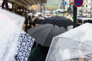 crowd of pedestrians with umbrellas on a rainy day in the city