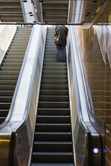man on an escalator at a metro station