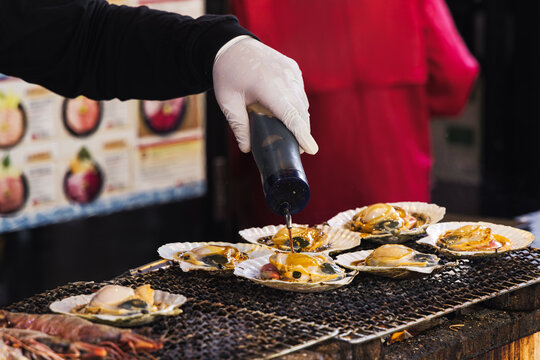 chef at a street kitchen preparing seafood at Tsukiji-market in Tokyo, Japan