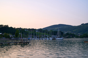 Lake Mondsee in Alps mountains, Austria. Beautiful sunset landscape, with boats and Pier. 