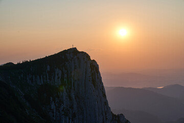 Cross in the mountains and incredible sunset. Upper Austria.