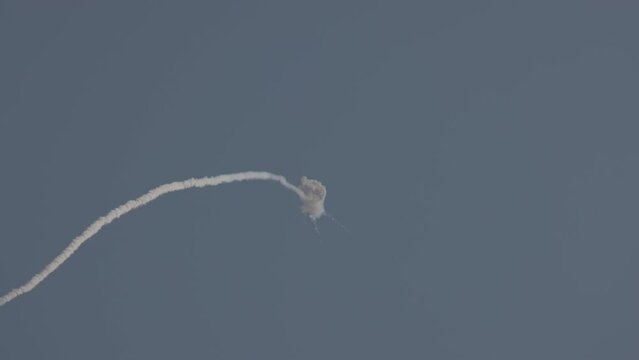 An anti-aircraft missile has hit its target in the blue sky. Explosion in the air. Air defence. Shot down. Smoke in the sky after air missile attack, SAM. ProRes 422, 10 bit, ungraded C-LOG video