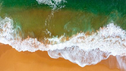 Wave on the beach with sand and turquoise waves aerial view