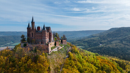 Fototapeta na wymiar Aerial drone view of medieval Hohenzollern castle on top of hill in autumn, Baden-Wurttemberg, Germany