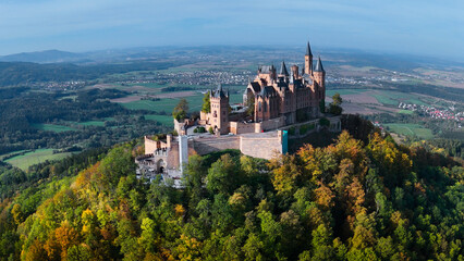 Aerial drone view of medieval Hohenzollern castle on top of hill in autumn, Baden-Wurttemberg,...