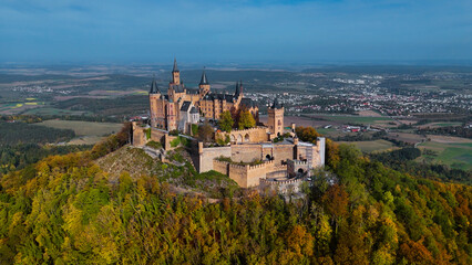 Fototapeta na wymiar Aerial drone view of medieval Hohenzollern castle on top of hill in autumn, Baden-Wurttemberg, Germany