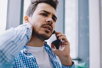 serious hipster guy concentrated on call