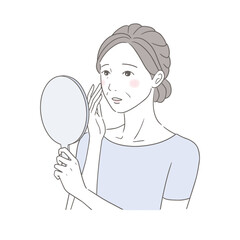 手鏡を見るお肌の変化に戸惑うシニア女性