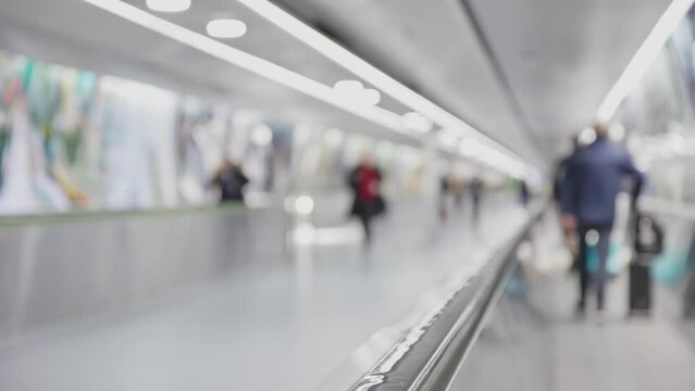 Blurred walkway with passengers, airport