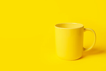 One ceramic mug on yellow background, space for text