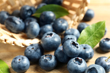 Fresh tasty blueberries on wooden table, closeup