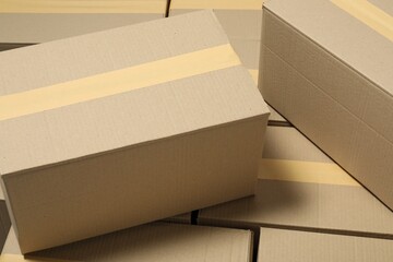 Many closed cardboard boxes with tape as background