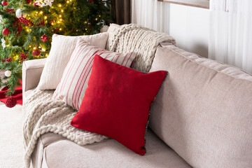 Cozy Christmas Ambiance, A Neutral-Toned Sofa Adorned with Textured Cushions, Rich Red Accent...