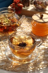 Aromatic herbal tea with anise star and honey on table