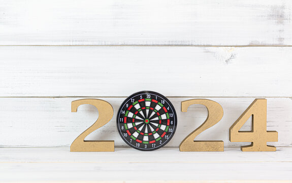 Upcoming 2024 New Year with Dartboard over white wood background, Target and Mission Conccept.