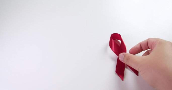 Placing a red ribbon on the right side of the frame which signifies the HIV-AIDS worldwide disease awareness and prevention.