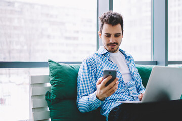  caucasian male reading incoming message via app on cellphone