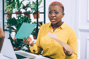 Angry black woman talking with colleague in office