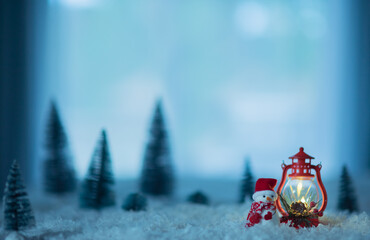 Miniature snowman in snow. Christmas holidays cool winter background with copy space for text.