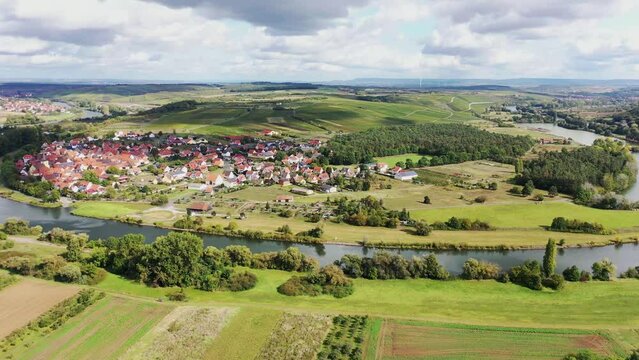 The Mainschleife near Volkach winds through the valley and is surrounded by fields and vineyards. Volkach, Kitzingen, Lower Franconia, Bavaria, Germany, Europe