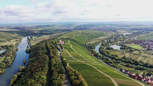 The Mainschleife near Volkach winds through the valley and is surrounded by fields and vineyards. Volkach, Kitzingen, Lower Franconia, Bavaria, Germany, Europe