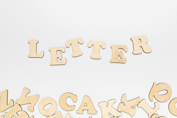 Lettering letter and wooden letters on a white background.