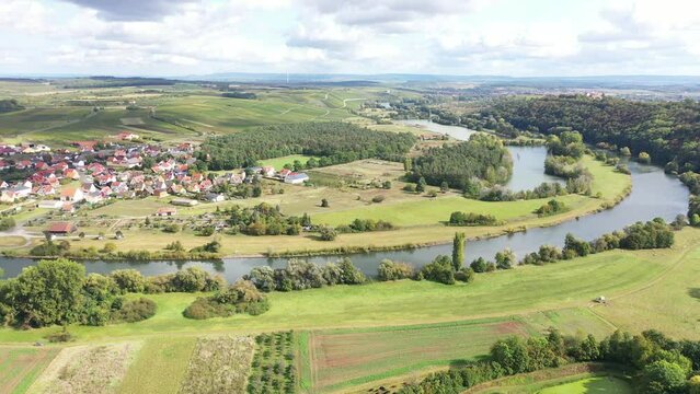 The Mainschleife near Volkach winds through the valley and is surrounded by fields and vineyards. Volkach, Kitzingen, Lower Franconia, Bavaria, Germany, Europe
