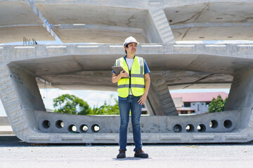 Professional senior Asian civil engineer working at the heavy infrastructure construction site, civil engineer - foreman inspecting the segmentation construction bridge.