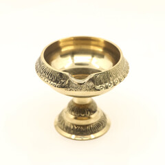 handcrafted brass oil diya lamp with stand used for decorative fire light in hindu festival and ceremony isolated in a white background