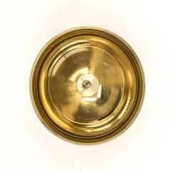 a shiny round brass oil lamp with wick holder isolated in a white background viewed from the top