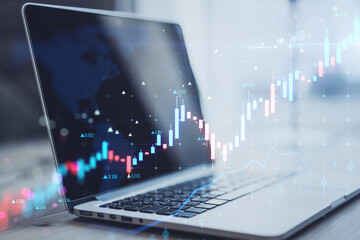 Close up of laptop with glowing candlestick forex chart on blurry background. Trade, finance and growing market concept. Double exposure. - obrazy, fototapety, plakaty