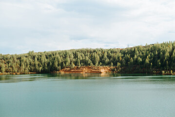 Landscape of lake, forest and sky on a sunny summer day