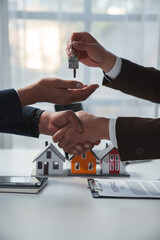 Real estate company to buy houses and land are delivering keys and houses to customers after agreeing to make a home purchase agreement and make a loan agreement. Discussion with a real estate agent - obrazy, fototapety, plakaty