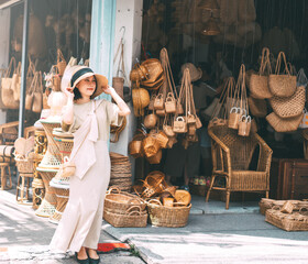 Young adult traveler asian woman travel and shopping at wicker souvenir shop at local street Chiang Mai, Thailand