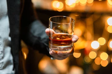 Fotobehang Bartender pours whiskey to customer in tavern © Thitisak
