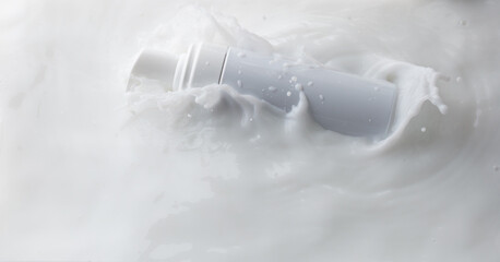 Cosmetic container white lotion droplet fly splashing. Milk lotion pour float to cosmetic bottle....