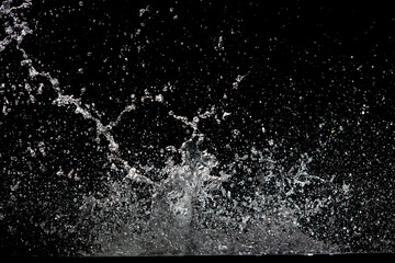 Blur Defocus Image of Water hit wall ground, explode into drop droplet. Amount Water attack impact...